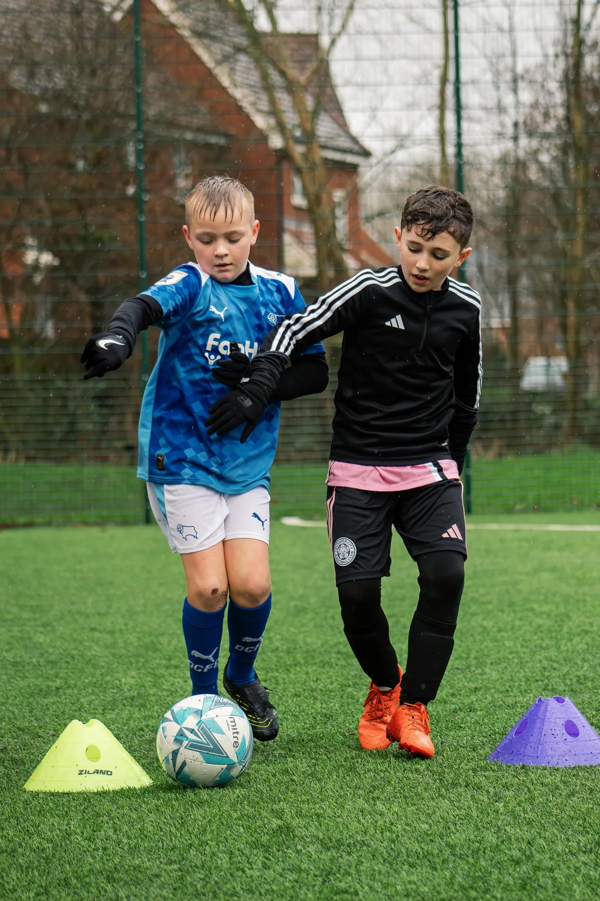 Two young players competing for the ball