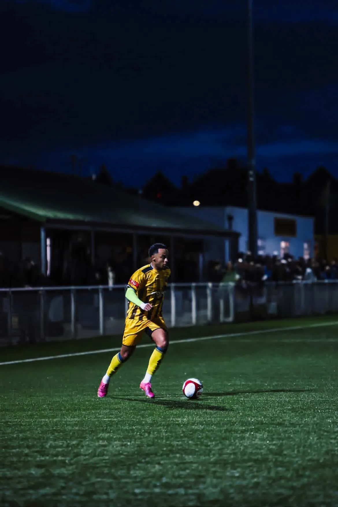 Footballer in action during an evening match